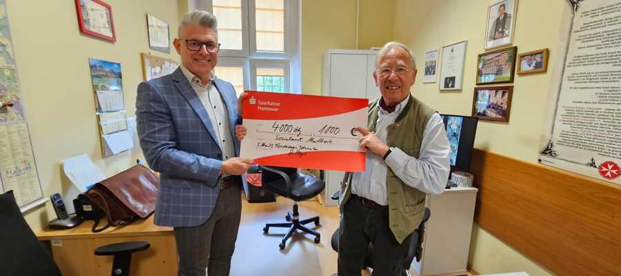 dr Meyl i dyrektor MOPS z symbolicznym czekiem na 1000 euro